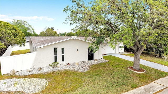9334 Ledgestone Ln, Port Richey, FL 34668 - view of front of home featuring stucco siding, a front yard, fence, an attached garage, and driveway