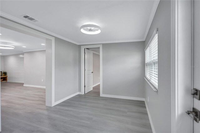 9334 Ledgestone Ln, Port Richey, FL 34668 - spare room featuring visible vents, baseboards, crown molding, and wood finished floors