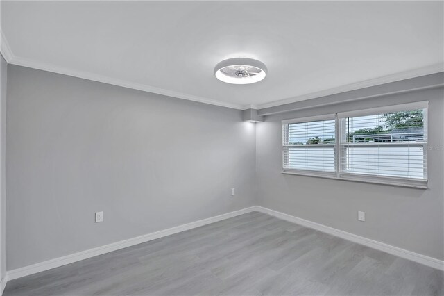 9334 Ledgestone Ln, Port Richey, FL 34668 - unfurnished room with crown molding, baseboards, and wood finished floors