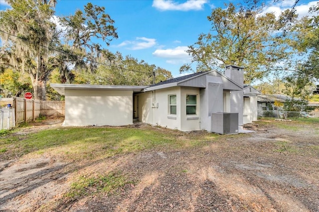 rear view of property with a lawn