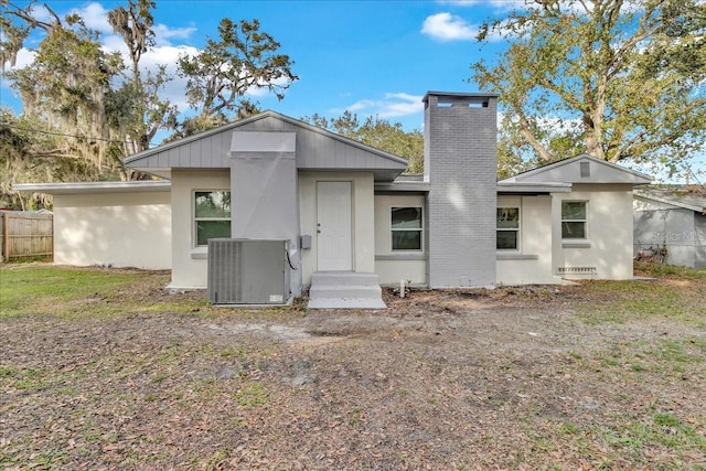 rear view of property featuring central AC unit