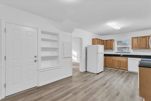 kitchen featuring built in shelves, sink, white appliances, and light hardwood / wood-style floors