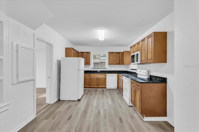 kitchen featuring light hardwood / wood-style floors, sink, and white appliances