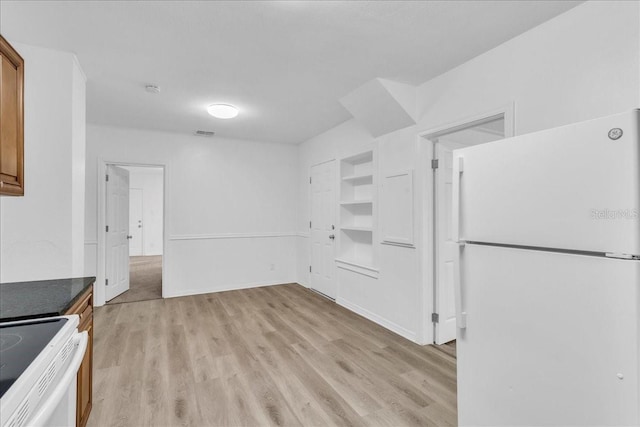 kitchen featuring light hardwood / wood-style floors and white appliances