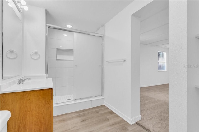 bathroom featuring vanity, hardwood / wood-style flooring, and walk in shower