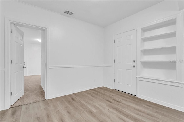 unfurnished room with light wood-type flooring