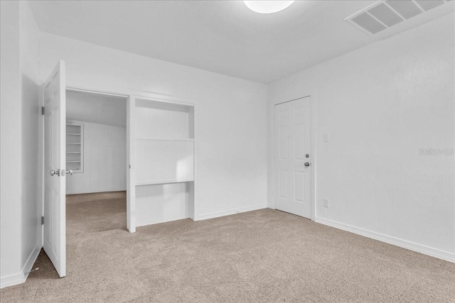 unfurnished bedroom with light colored carpet