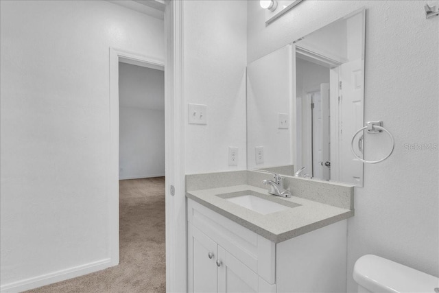 bathroom with toilet and vanity