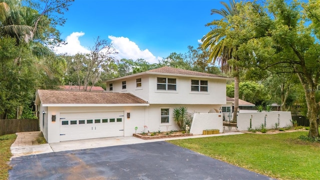 view of front of home with a garage and a front lawn