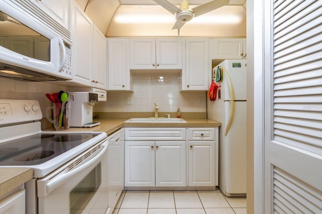 kitchen with light tile patterned flooring, white appliances, backsplash, and white cabinets