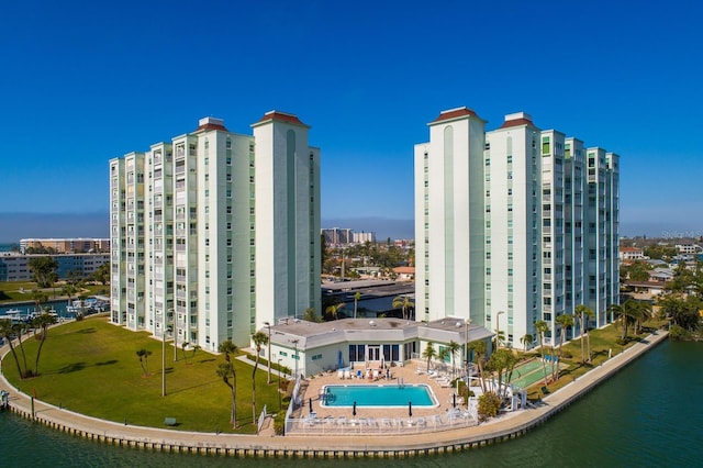 view of building exterior featuring a view of city and a water view