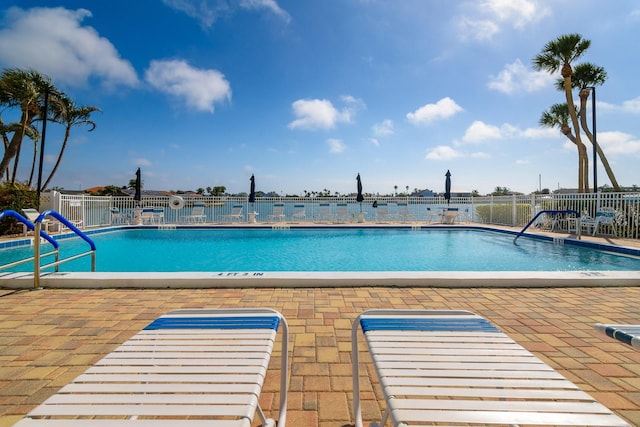 pool featuring a patio area and fence