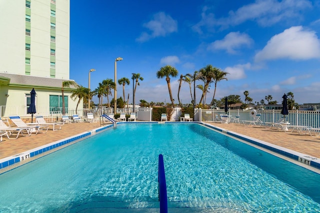 community pool featuring a patio area and fence