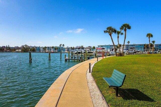 view of dock featuring a water view and a lawn