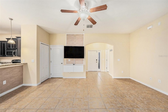 unfurnished living room with light tile patterned floors and ceiling fan