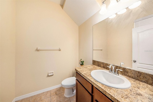 bathroom with vaulted ceiling, vanity, toilet, and tile patterned flooring