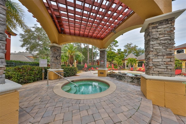 view of patio / terrace with a pergola and a hot tub