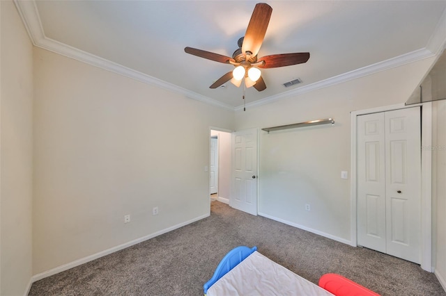 unfurnished bedroom featuring ceiling fan, carpet, and crown molding