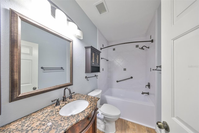 full bathroom featuring hardwood / wood-style floors, toilet, vanity, and  shower combination