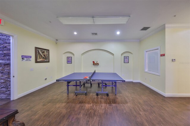 rec room featuring dark wood-type flooring and ornamental molding