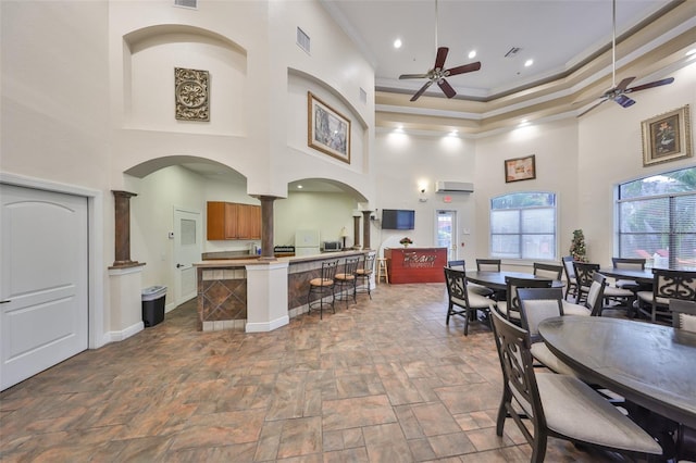 2160 Chianti Pl Unit 11-0117, Palm Harbor, FL 34683 - dining space featuring a towering ceiling, visible vents, a ceiling fan, and ornamental molding