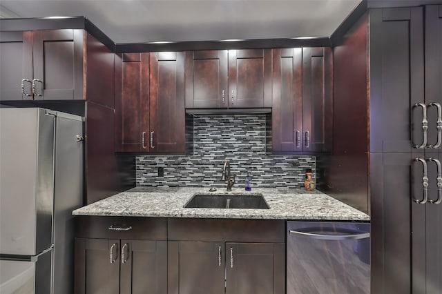 2160 Chianti Pl Unit 11-0117, Palm Harbor, FL 34683 - kitchen featuring light stone counters, appliances with stainless steel finishes, tasteful backsplash, and a sink