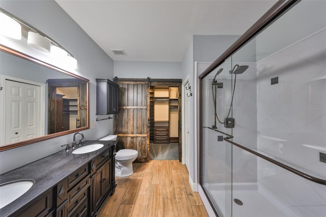 2160 Chianti Pl Unit 11-0117, Palm Harbor, FL 34683 - bathroom featuring wood finished floors, visible vents, a sink, a closet, and a stall shower