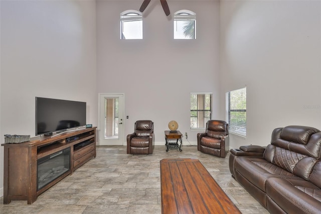 2160 Chianti Pl Unit 11-0117, Palm Harbor, FL 34683 - living room with baseboards, a towering ceiling, and ceiling fan