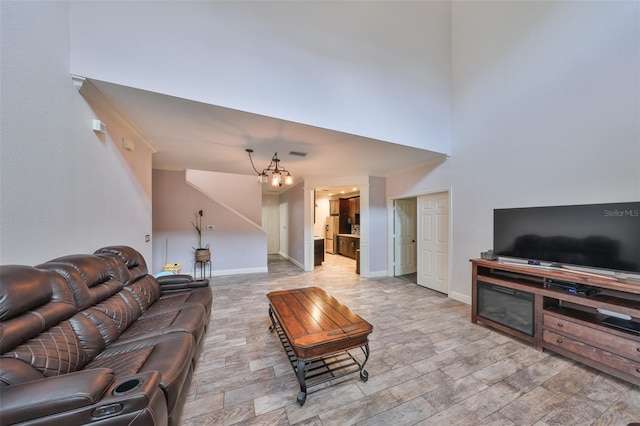 2160 Chianti Pl Unit 11-0117, Palm Harbor, FL 34683 - living room featuring a high ceiling, baseboards, a chandelier, and visible vents