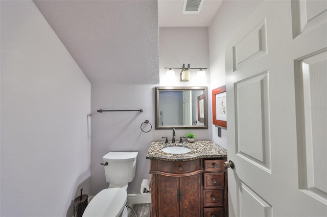 2160 Chianti Pl Unit 11-0117, Palm Harbor, FL 34683 - bathroom with baseboards, visible vents, vanity, and toilet