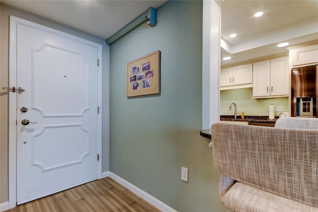 foyer with sink and light wood-type flooring