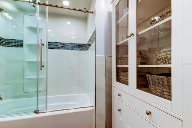 bathroom featuring bath / shower combo with glass door