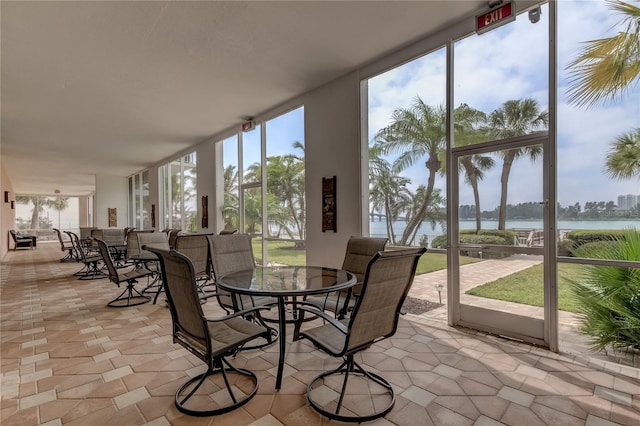 unfurnished sunroom with a water view and a healthy amount of sunlight