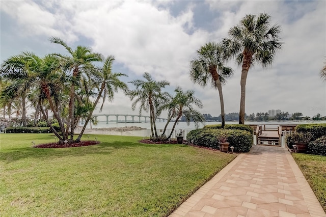 view of property's community with a yard and a water view