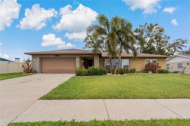 single story home featuring a garage and a front yard