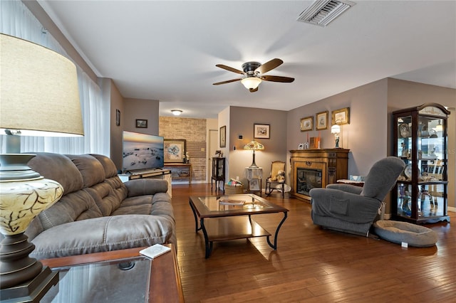 living room featuring ceiling fan and dark wood-type flooring