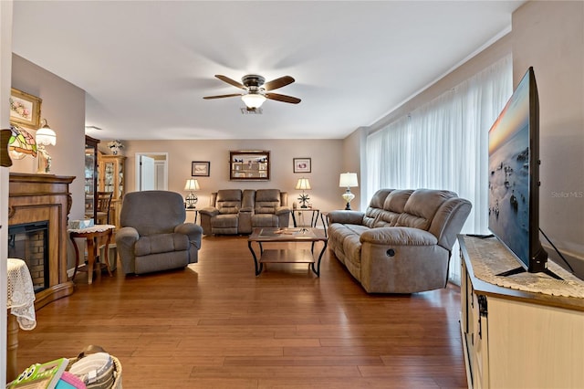 living room with ceiling fan and dark hardwood / wood-style flooring