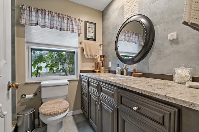 bathroom featuring toilet and vanity