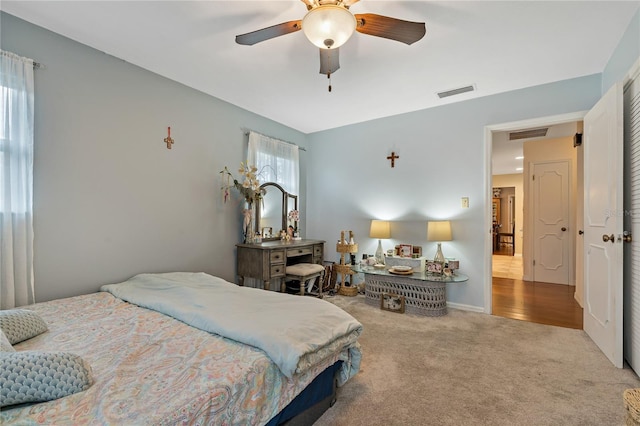 bedroom with ceiling fan and light colored carpet