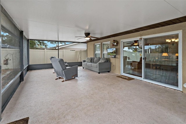 unfurnished sunroom featuring ceiling fan