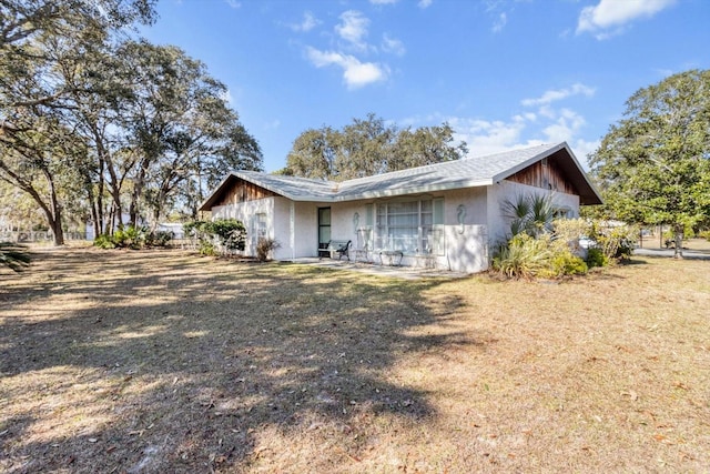 view of property exterior with a lawn