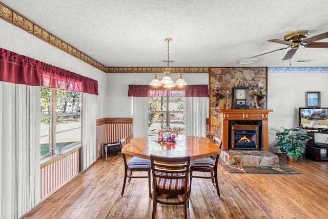 dining area featuring plenty of natural light, a textured ceiling, and hardwood / wood-style flooring