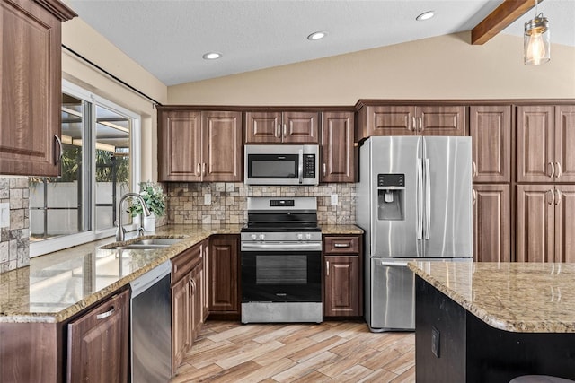 kitchen featuring tasteful backsplash, vaulted ceiling with beams, light stone counters, appliances with stainless steel finishes, and a sink