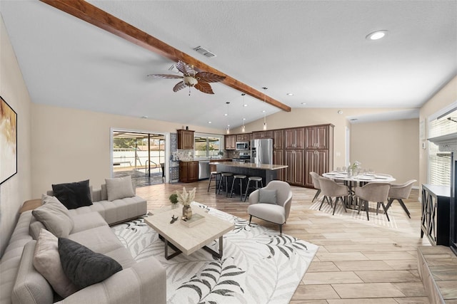 living area with light wood finished floors, vaulted ceiling with beams, visible vents, recessed lighting, and ceiling fan