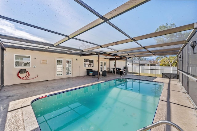 view of swimming pool featuring a fenced in pool, fence, glass enclosure, french doors, and a patio