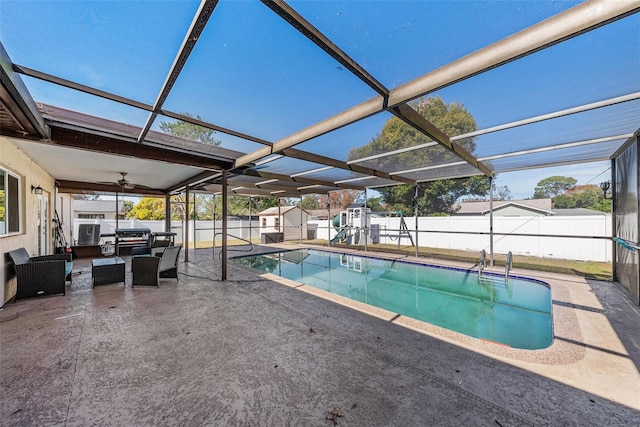view of swimming pool featuring a storage unit, a fenced in pool, a fenced backyard, and a patio