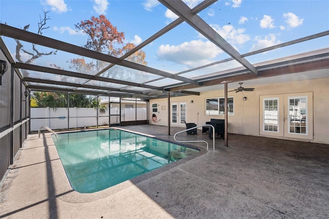 view of swimming pool with a patio area, glass enclosure, french doors, fence, and a fenced in pool