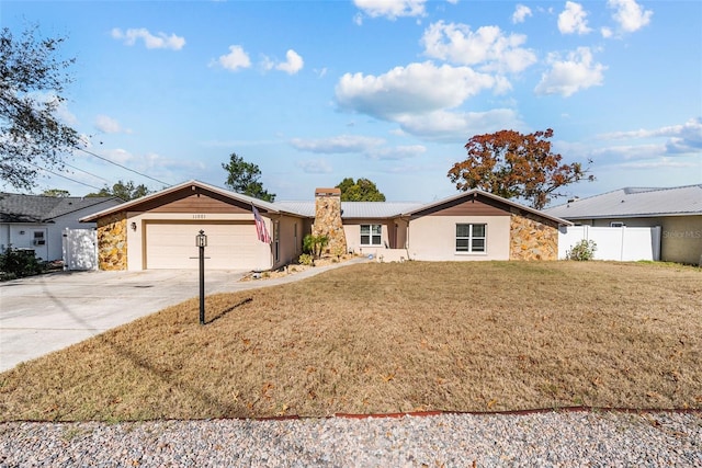 single story home featuring a chimney, fence, driveway, a front yard, and a garage