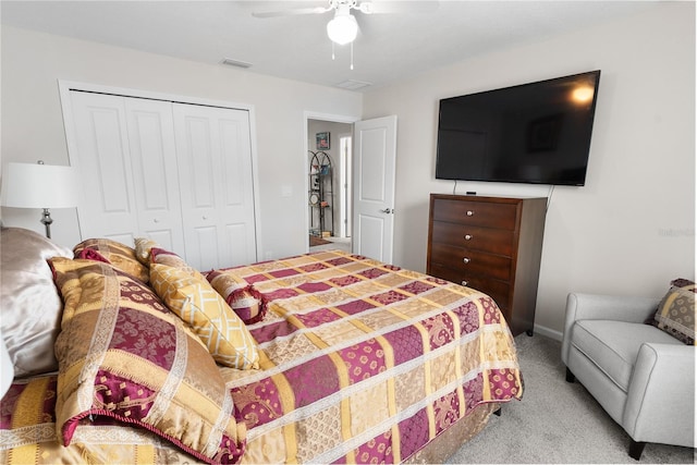 bedroom featuring light carpet, ceiling fan, and a closet