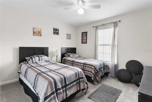 carpeted bedroom featuring multiple windows and ceiling fan